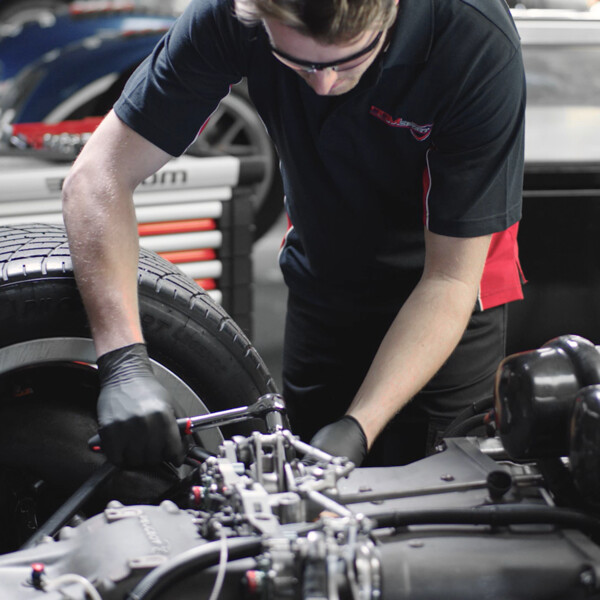 Automotive mechanic using FACOM tools to repair an engine